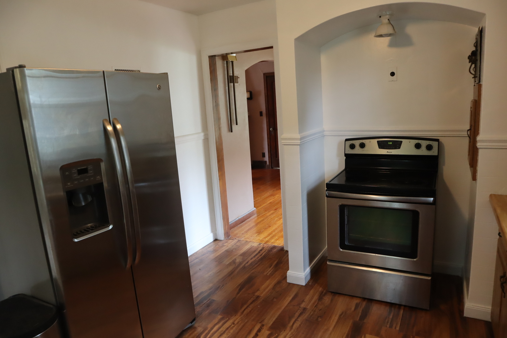 210 Red Oak Road Walnut, IL 61376 - Photo 8 of 26 a kitchen with a refrigerator stove and wooden floor