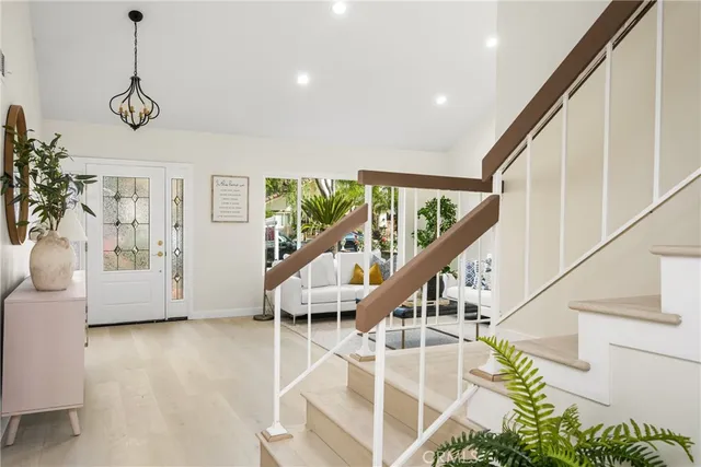 a kitchen with a dining table chairs sink and cabinets