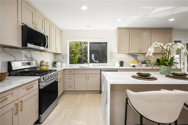 a bathroom with a granite countertop sink mirror bathtub and toilet