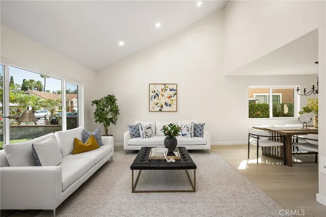 a kitchen with a dining table chairs refrigerator and cabinets