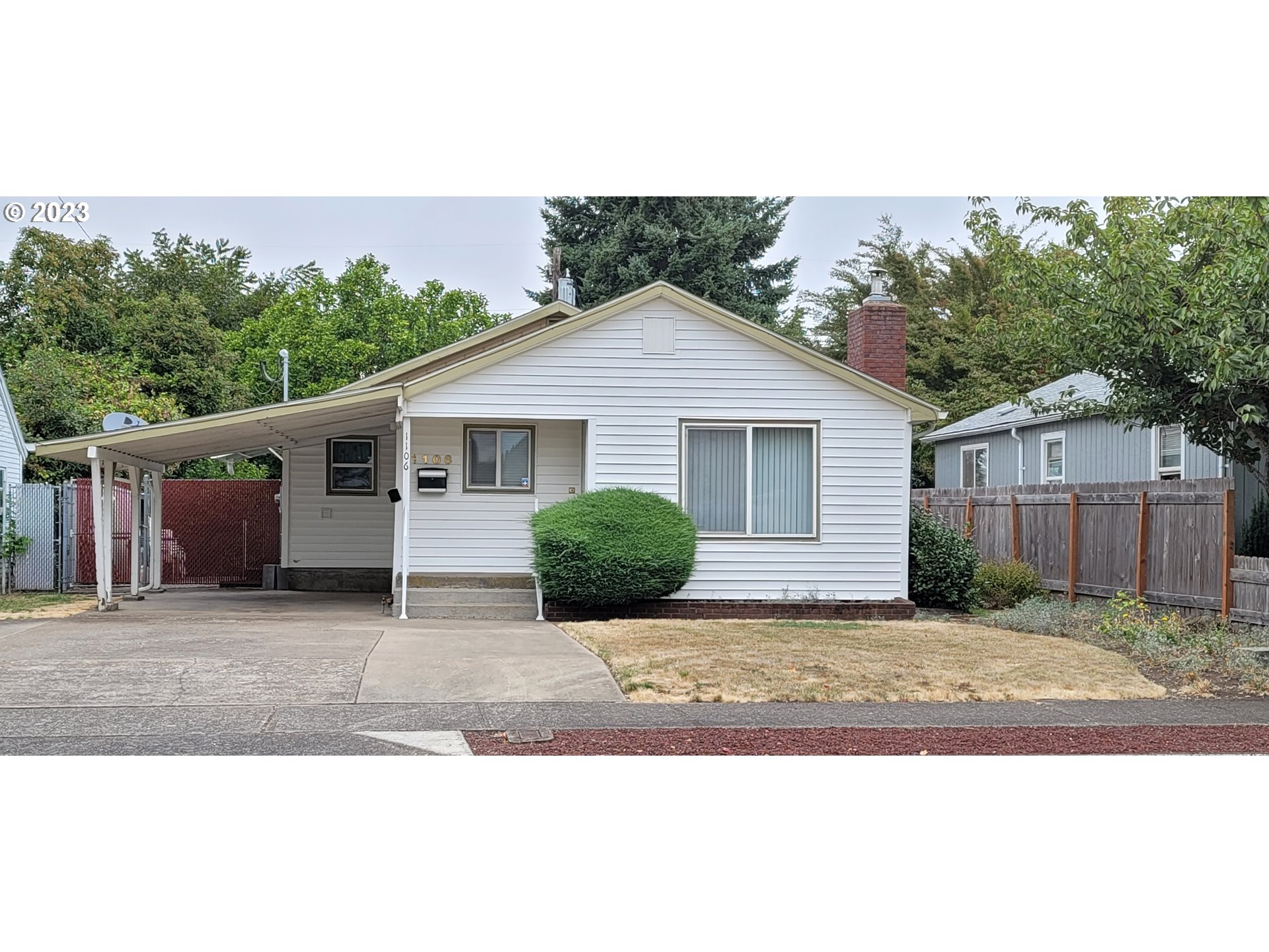 1106 J Street Springfield, OR 97477 - Photo 1 of 17 a front view of a house with a yard and potted plants