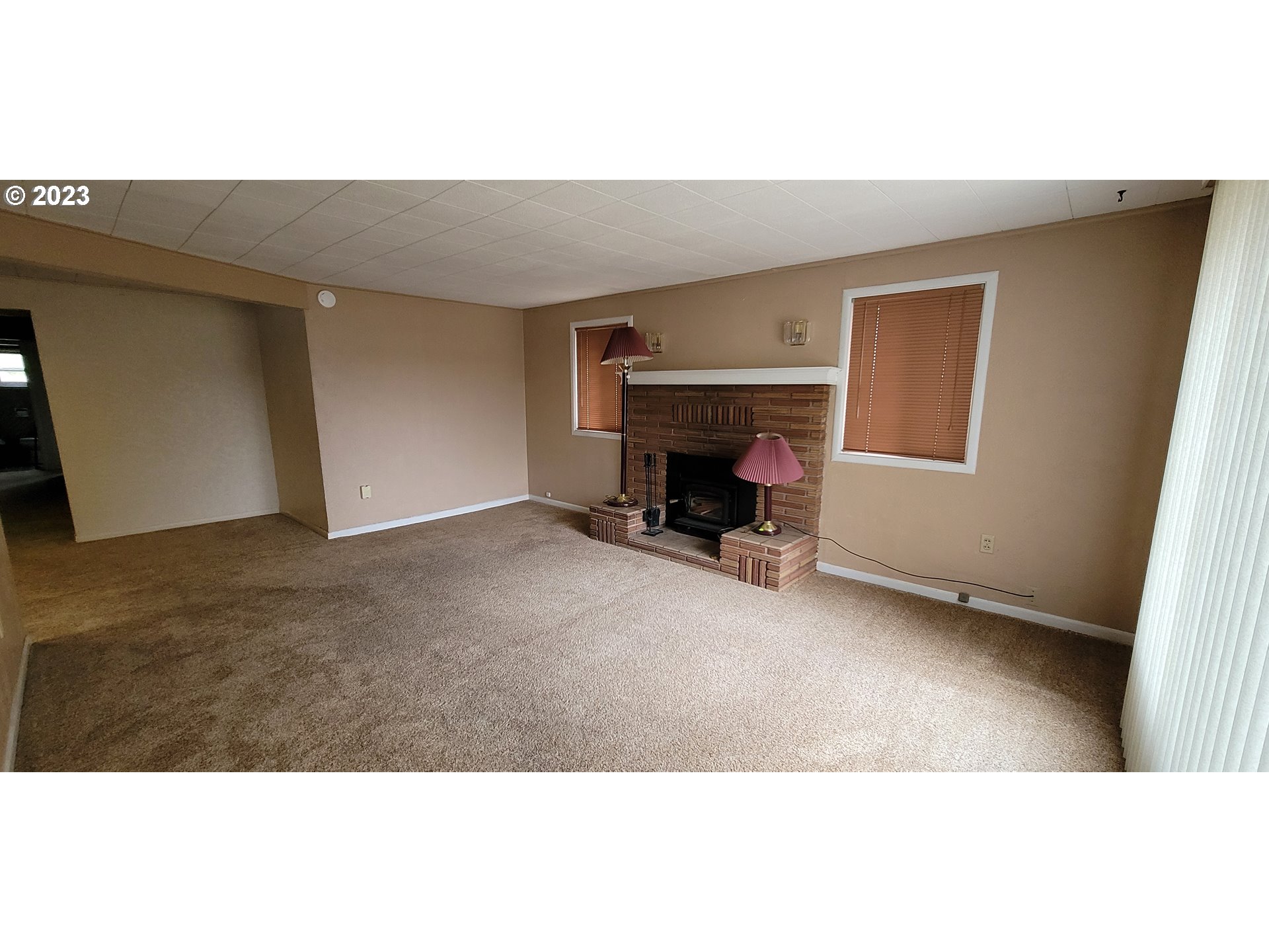 1106 J Street Springfield, OR 97477 - Photo 2 of 17 a view of an empty room with a fireplace
