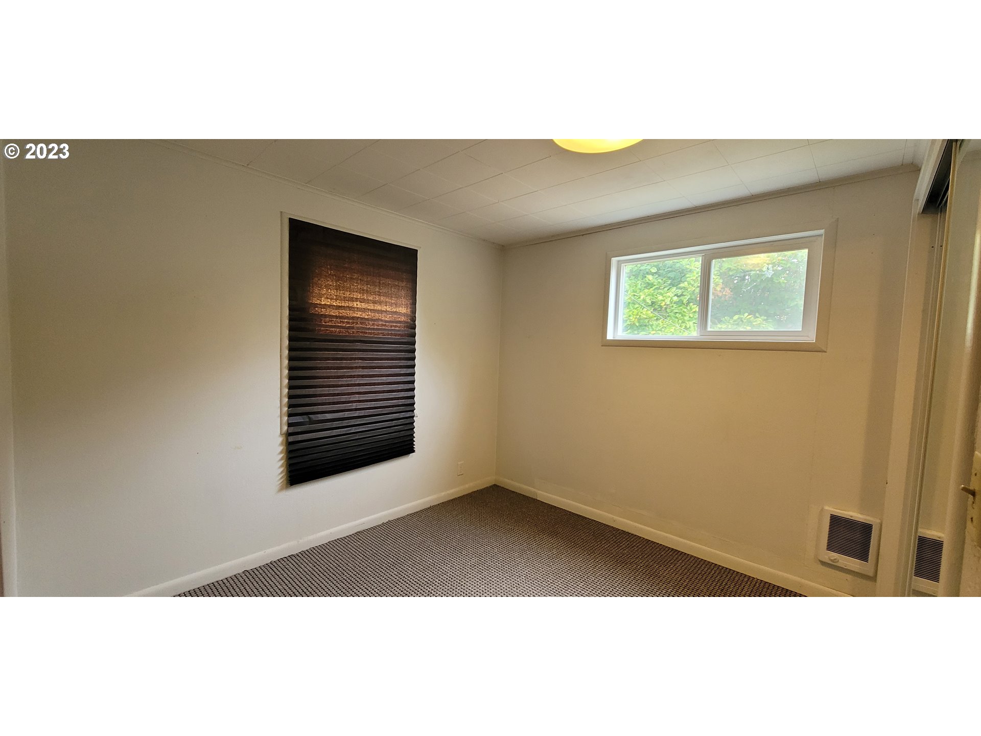 1106 J Street Springfield, OR 97477 - Photo 10 of 17 a view of an empty room with windows