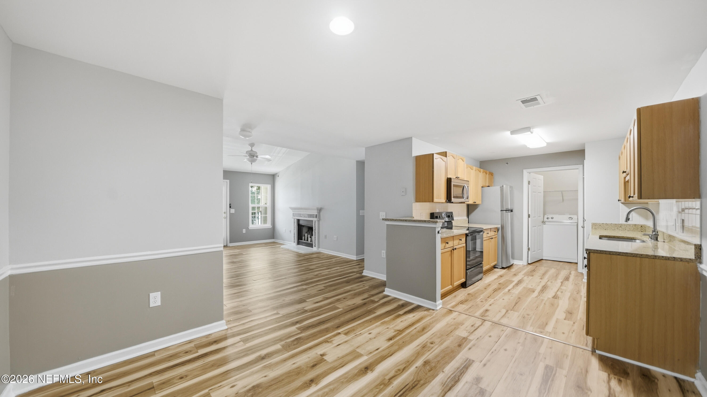 23699 Bahama Point, Unit 1126 Fernandina Beach, FL 32034 - Photo 11 of 50 a kitchen with granite countertop a sink cabinets and stainless steel appliances