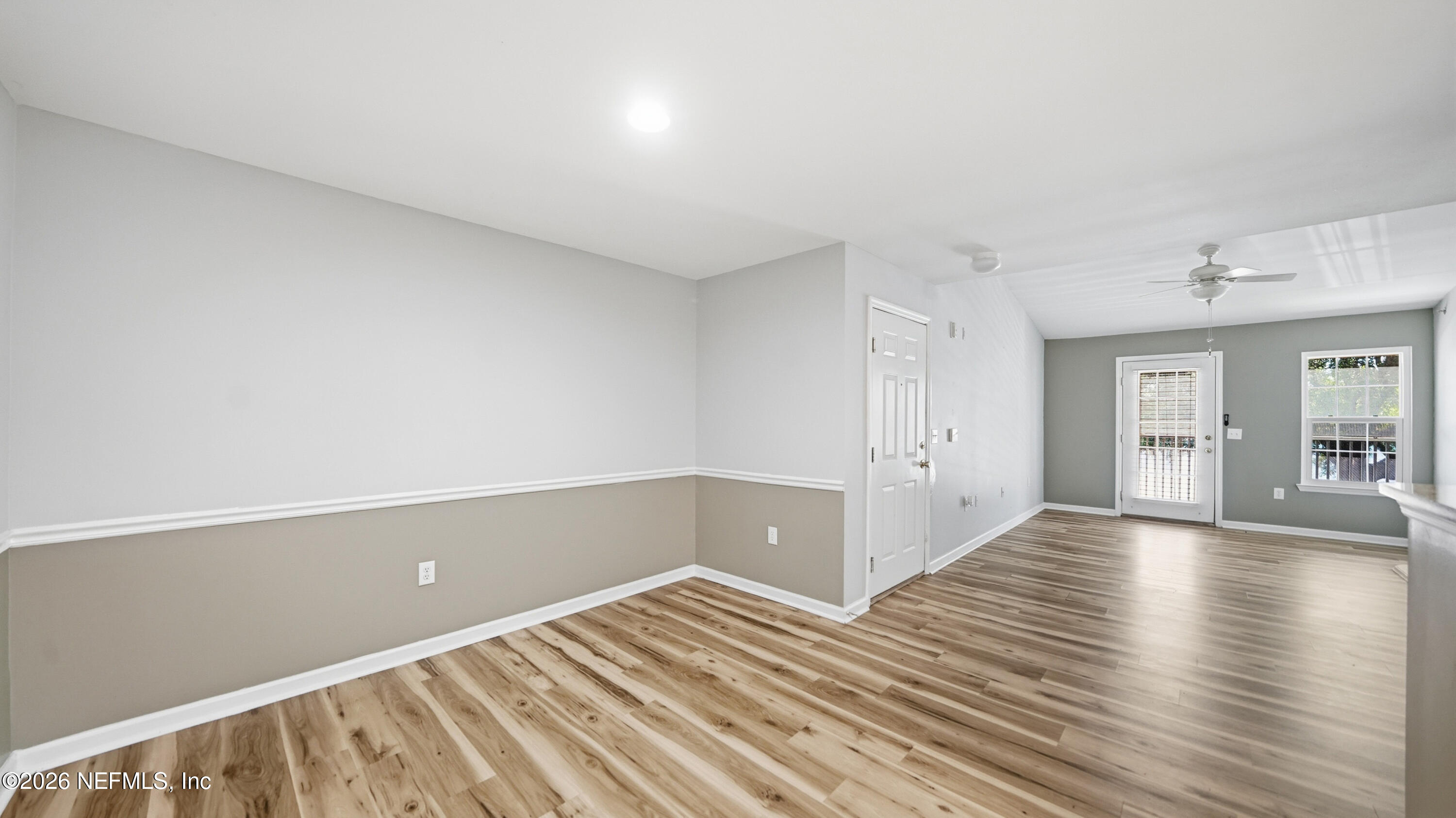 23699 Bahama Point, Unit 1126 Fernandina Beach, FL 32034 - Photo 12 of 50 an empty room with wooden floor and windows