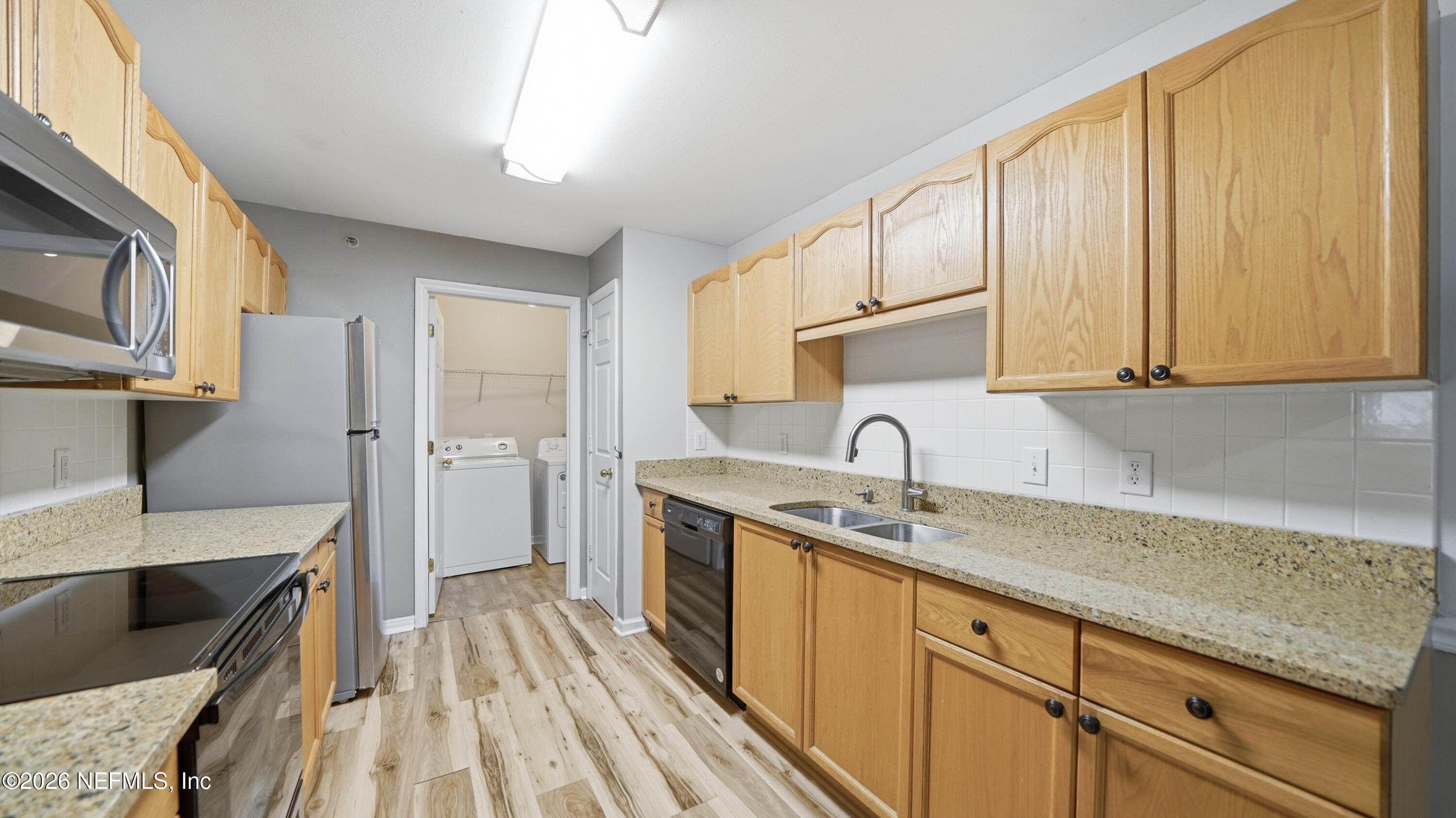 23699 Bahama Point, Unit 1126 Fernandina Beach, FL 32034 - Photo 15 of 50 a kitchen with a sink stove and cabinets