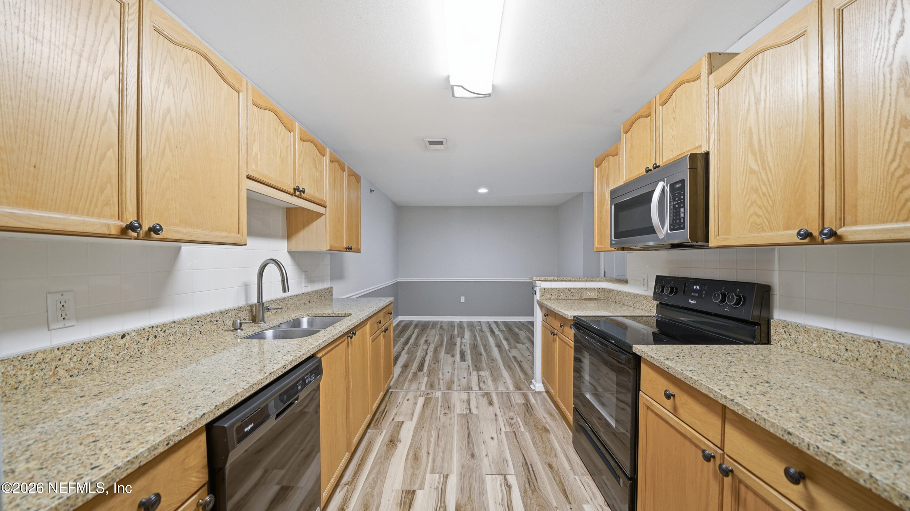 23699 Bahama Point, Unit 1126 Fernandina Beach, FL 32034 - Photo 17 of 50 a kitchen with a sink stove and microwave
