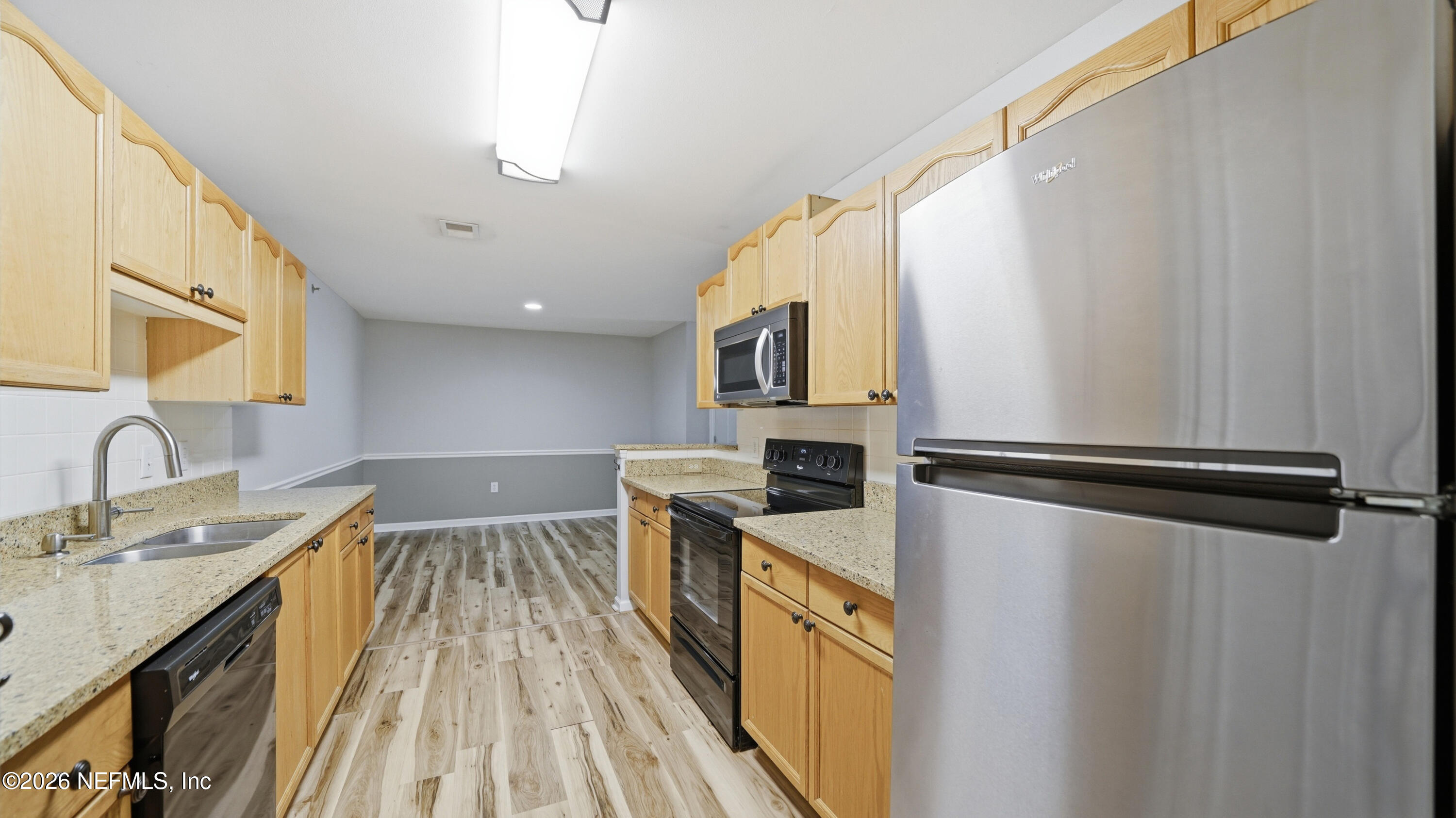 23699 Bahama Point, Unit 1126 Fernandina Beach, FL 32034 - Photo 18 of 50 a kitchen with a refrigerator a sink and cabinets