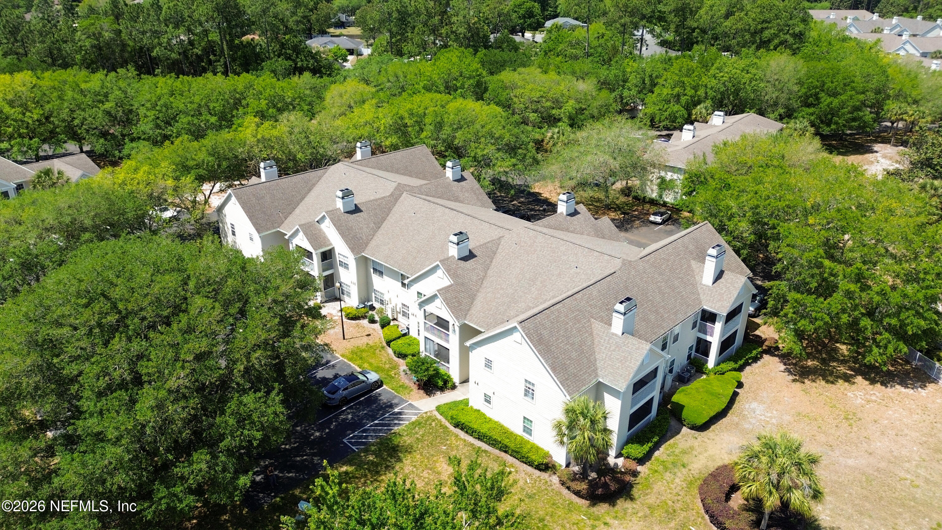 23699 Bahama Point, Unit 1126 Fernandina Beach, FL 32034 - Photo 38 of 50 an aerial view of a house with a yard and large trees