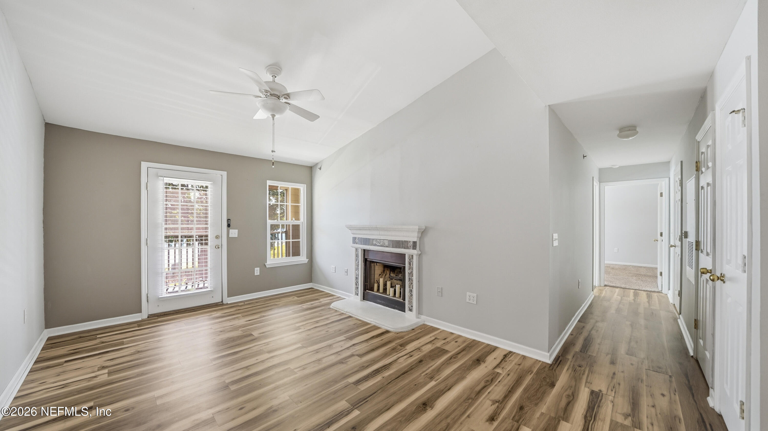 23699 Bahama Point, Unit 1126 Fernandina Beach, FL 32034 - Photo 4 of 50 wooden floor fireplace and natural light in room