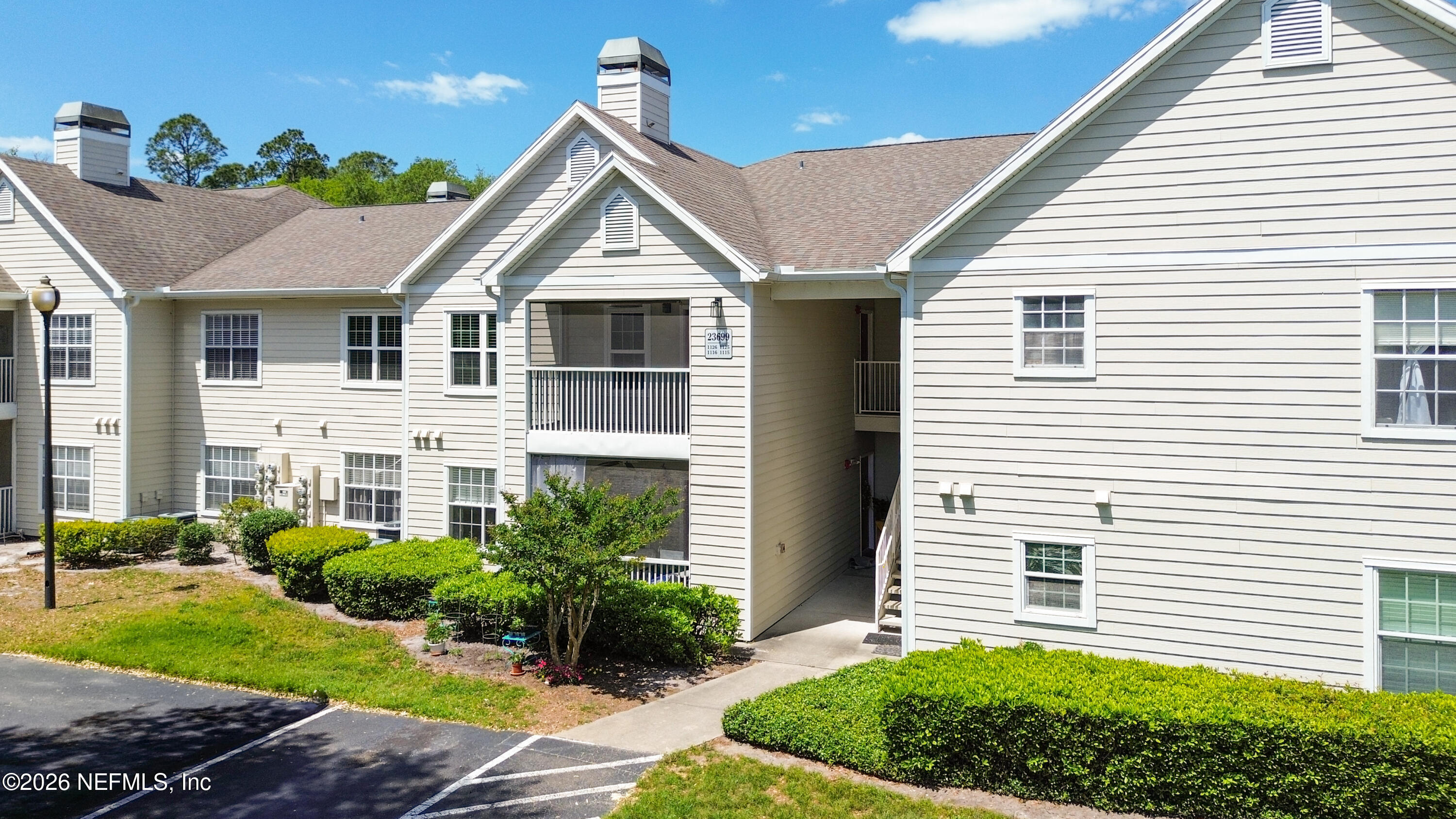 23699 Bahama Point, Unit 1126 Fernandina Beach, FL 32034 - Photo 48 of 50 a view of a white house next to a yard and plants