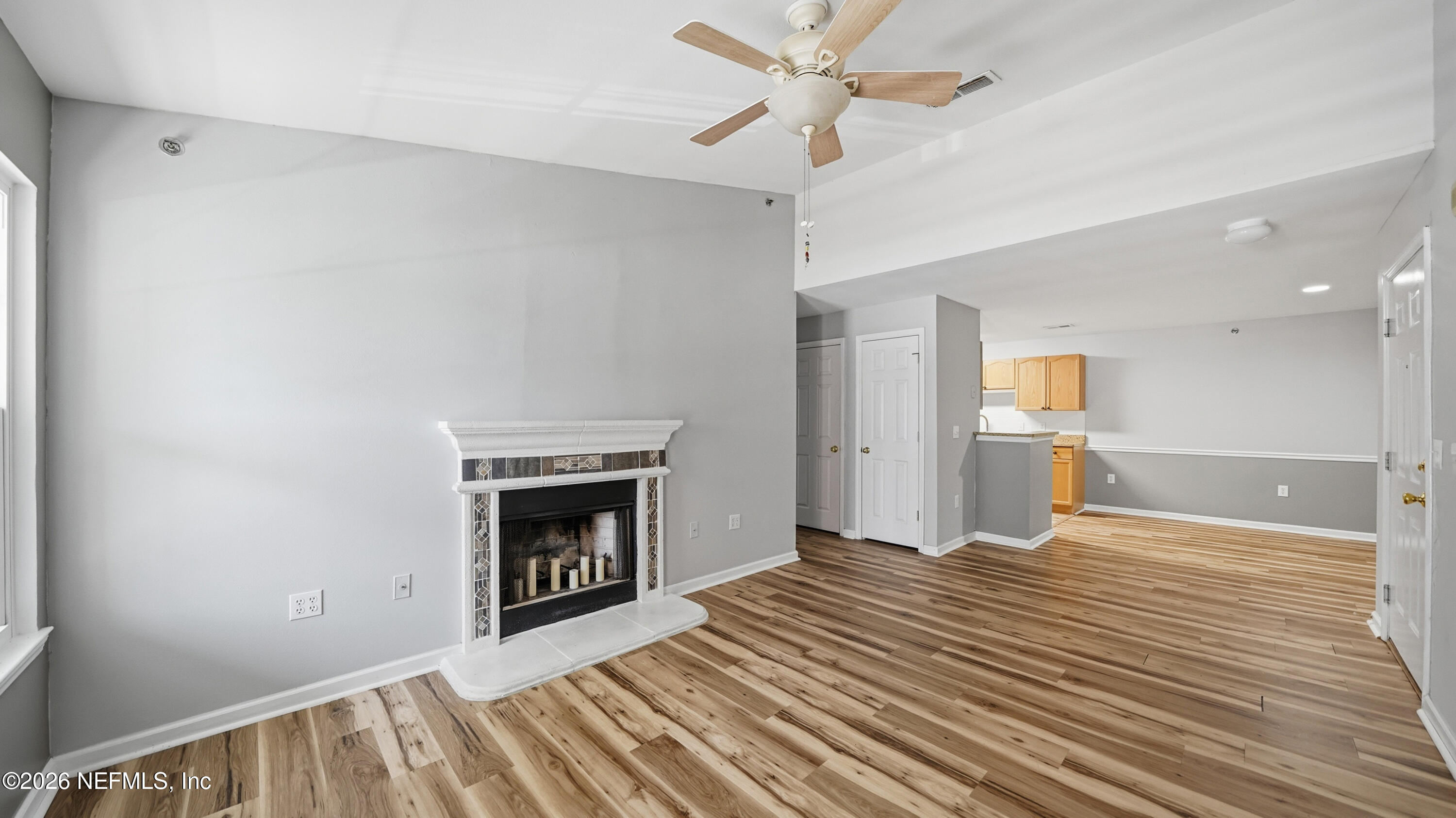 23699 Bahama Point, Unit 1126 Fernandina Beach, FL 32034 - Photo 6 of 50 a view of empty room with wooden floor and fireplace