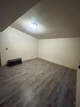 an empty room with wooden floor