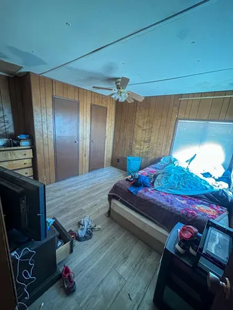 a bedroom with two beds and a closet