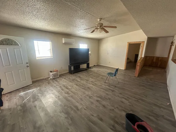 a view of livingroom with hardwood floor and a ceiling fan