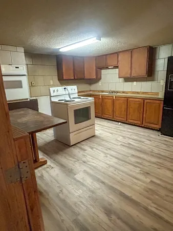 a kitchen with a stove a sink and a refrigerator