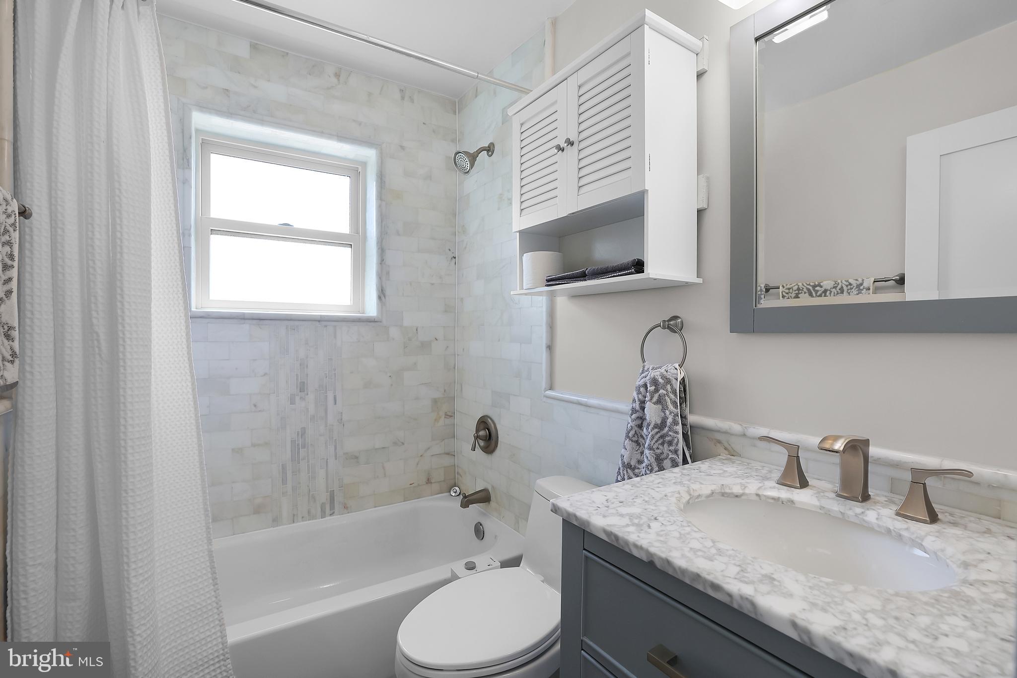 1225 Gallatin Street Northeast Washington, DC 20017 - Photo 12 of 28 a bathroom with a granite countertop toilet sink and mirror