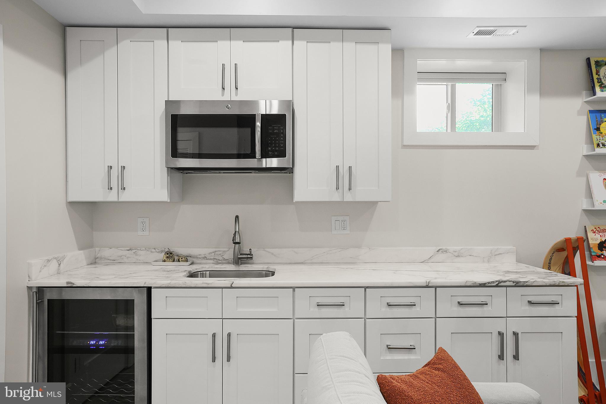 1225 Gallatin Street Northeast Washington, DC 20017 - Photo 20 of 28 a kitchen with stainless steel appliances white cabinets and a sink