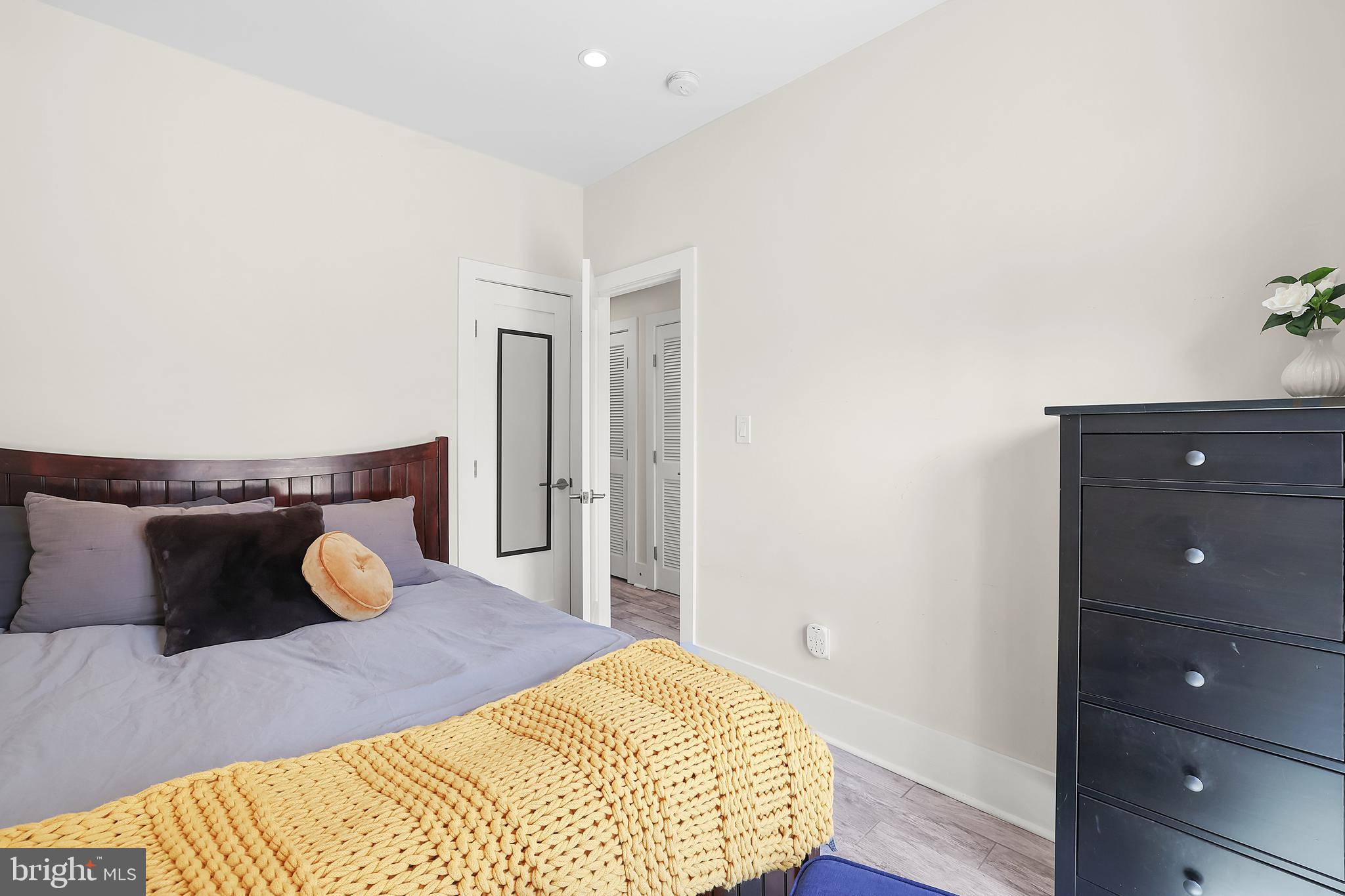 1225 Gallatin Street Northeast Washington, DC 20017 - Photo 24 of 28 a bedroom with a bed and cabinets