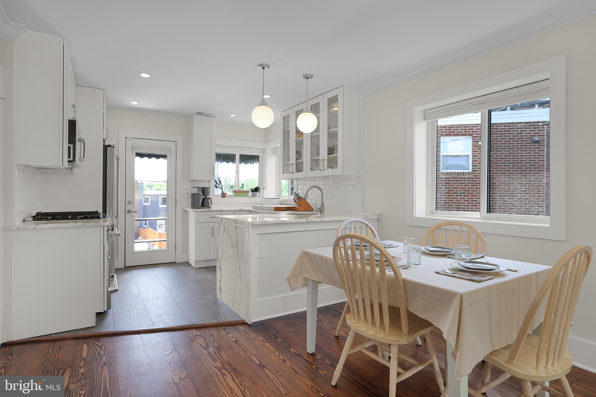 1225 Gallatin Street Northeast Washington, DC 20017 - Photo 5 of 28 a dining room with wooden floor and a refrigerator