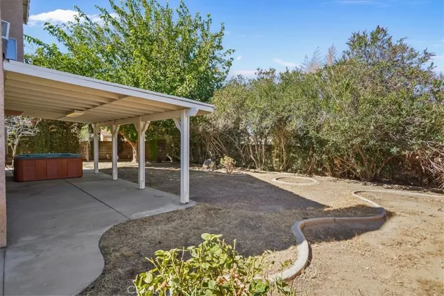 a view of a patio with table and chairs with wooden fence and plants