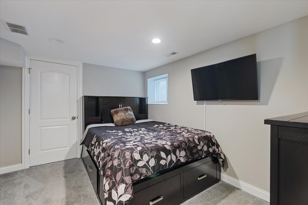 9124 South Bell Avenue Chicago, IL 60643 - Photo 29 of 35 a bedroom with a bed and a flat screen tv