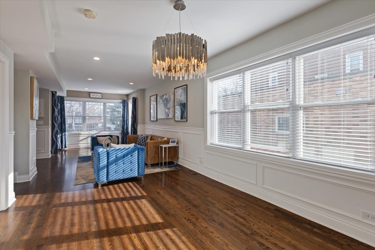 9124 South Bell Avenue Chicago, IL 60643 - Photo 6 of 35 a dining room with wooden floor a chandelier a glass table and chairs