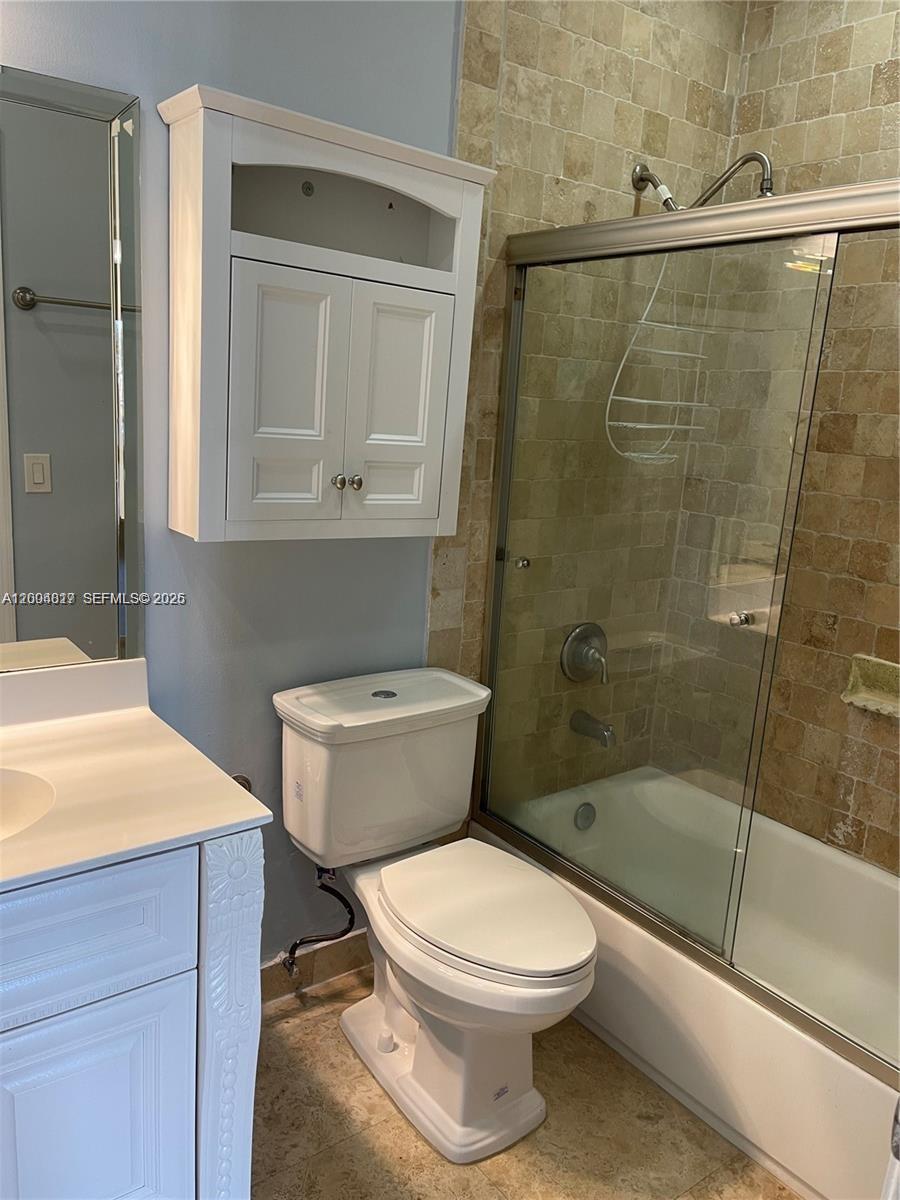 2415 Northwest 16th St Road, Unit 102 Miami, FL 33125 - Photo 7 of 19 a bathroom with a toilet a sink and shower