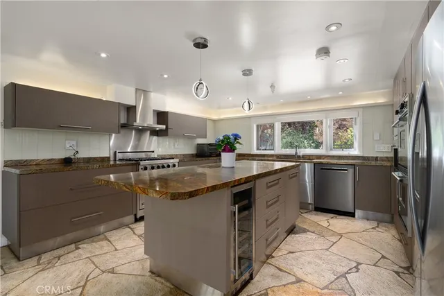 a kitchen with stainless steel appliances granite countertop a sink counter space cabinets and a large window