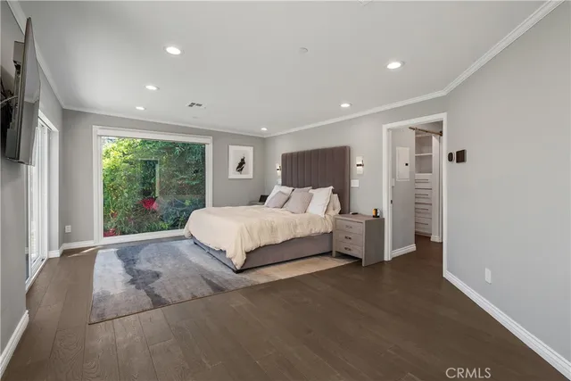 a spacious bedroom with a bed and large window