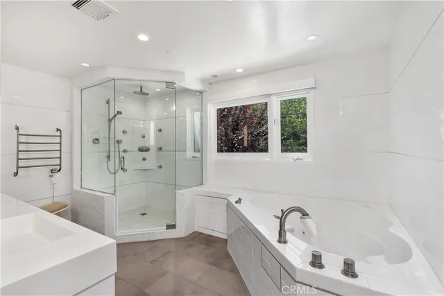 a bathroom with a bathtub sink and shower