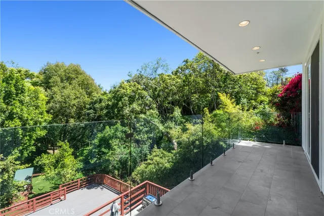 a backyard of a house with a yard and outdoor seating
