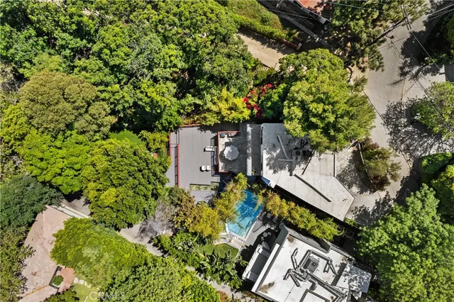 an aerial view of a house with a yard