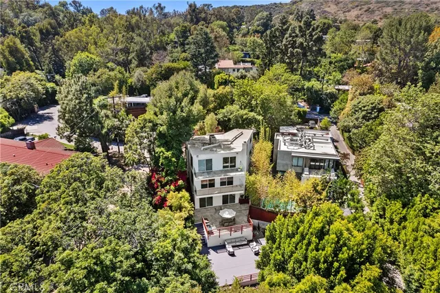 an aerial view of a house with a yard and garden