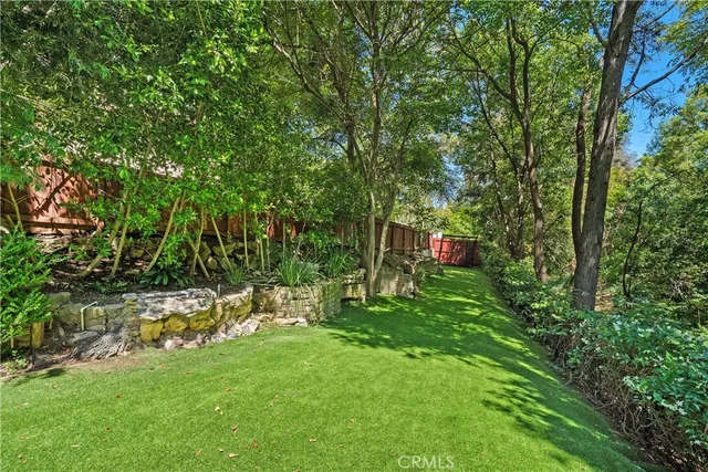 a green field with lots of trees in it
