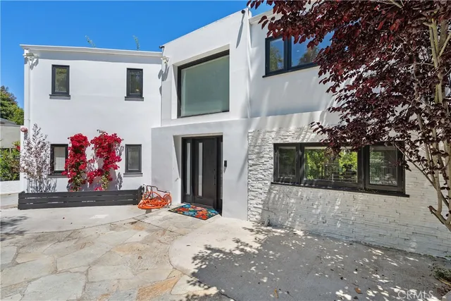 a view of a house with a snow on the road