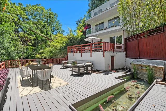 a view of a roof deck with wooden floor and fence