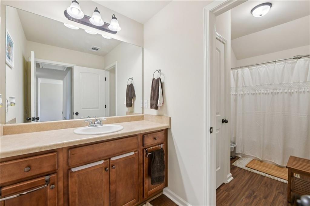 2002 Bridgewater Pass Hampton, GA 30228 - Photo 23 of 35 a bathroom with a granite countertop sink a toilet and a mirror