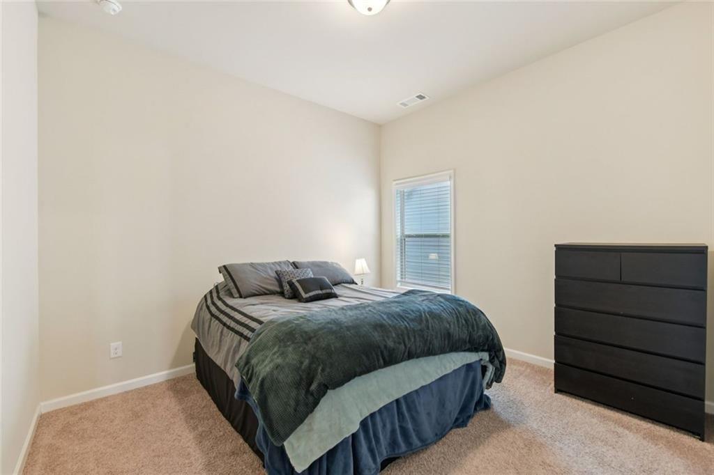 2002 Bridgewater Pass Hampton, GA 30228 - Photo 24 of 35 a bedroom with a bed and cabinet