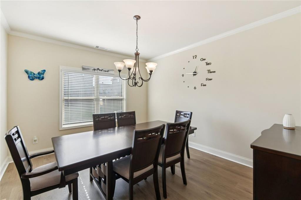 2002 Bridgewater Pass Hampton, GA 30228 - Photo 10 of 35 a view of a dining room with furniture and wooden floor