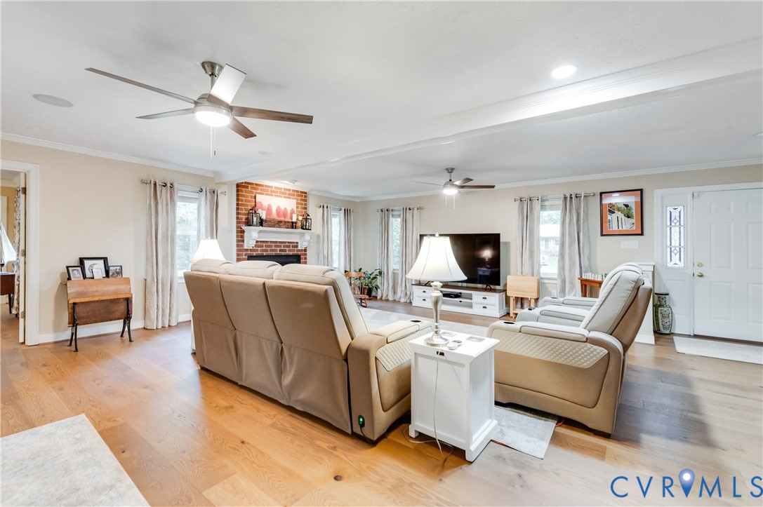 19229 Turkey Road Rockville, VA 23146 - Photo 11 of 44 a living room with furniture flat screen tv and a fireplace