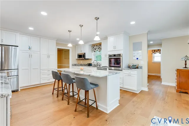 a view of a hallway with wooden floor and windows