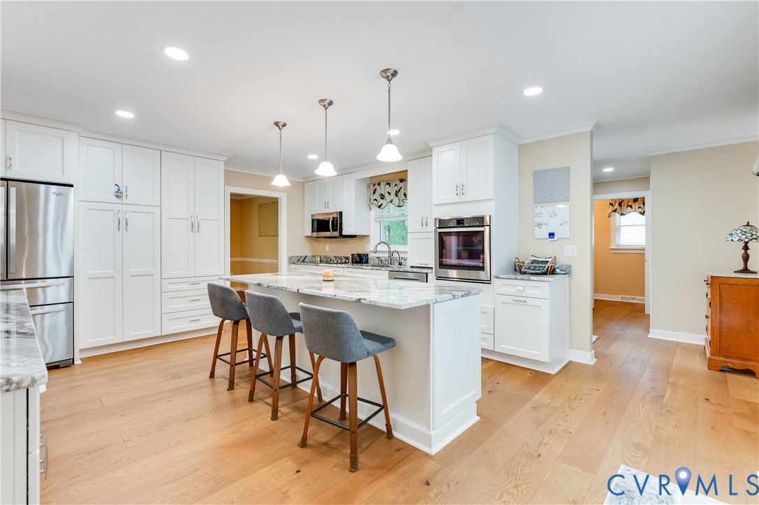 19229 Turkey Road Rockville, VA 23146 - Photo 22 of 44 a large kitchen with cabinets counter space dining table and stainless steel appliances