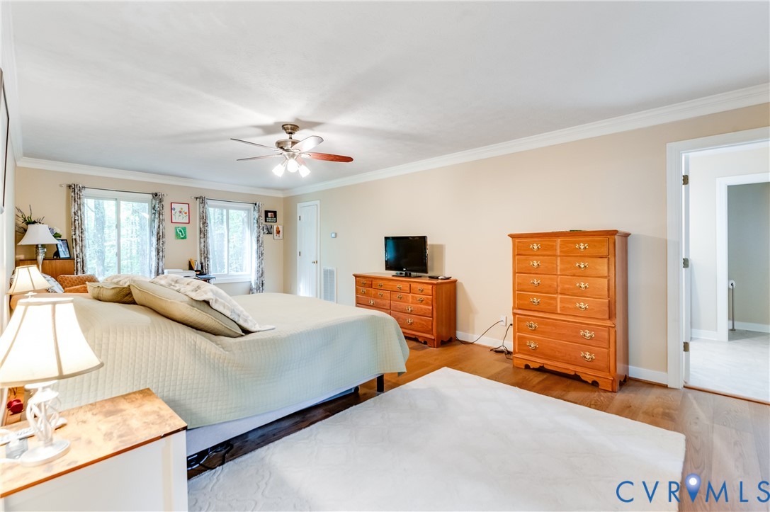 19229 Turkey Road Rockville, VA 23146 - Photo 24 of 44 a bedroom with a bed and a chandelier