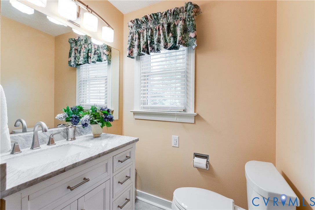 19229 Turkey Road Rockville, VA 23146 - Photo 34 of 44 a bathroom with a granite countertop sink mirror vanity and toilet