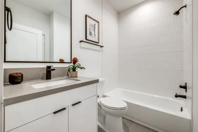 an aerial view of residential houses with outdoor space and lake view