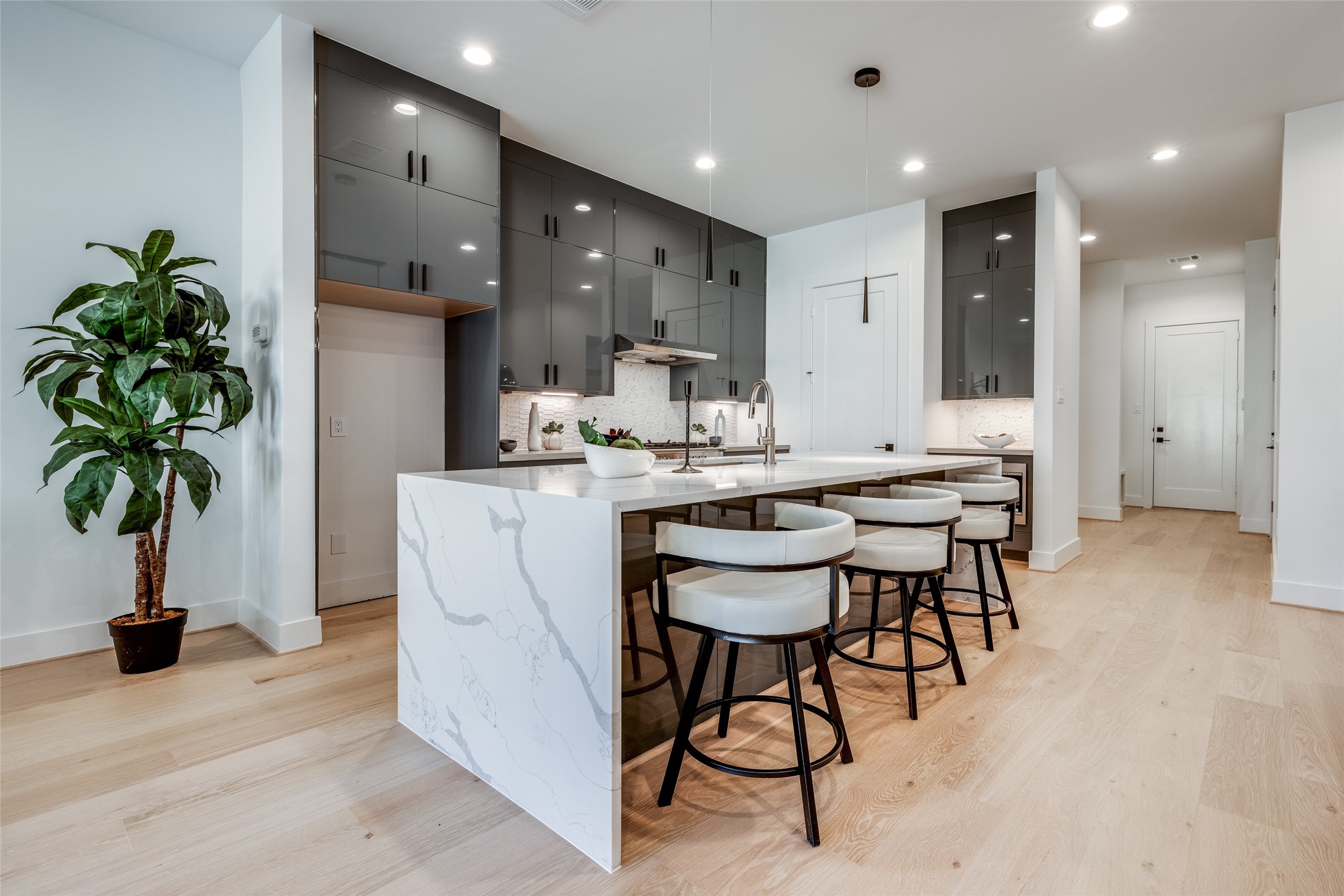 2412 Elmen Street Houston, TX 77019 - Photo 13 of 43 a dining room with kitchen island a chandelier and entryway