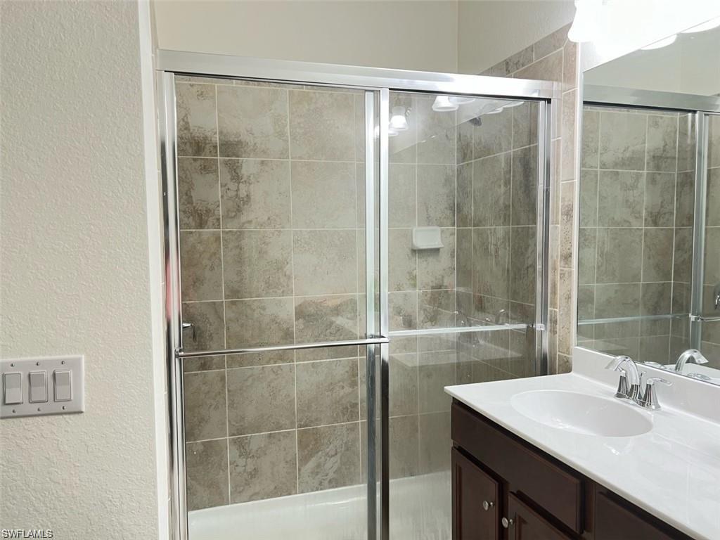 2775 Citrus Street Naples, FL 34120 - Photo 12 of 31 a bathroom with a shower sink and mirror