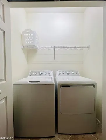 an empty room with closet and a chandelier fan