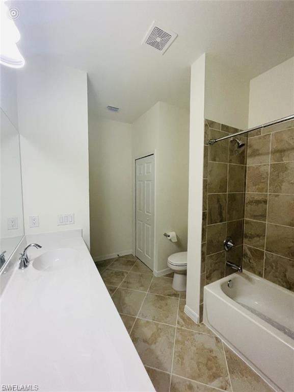 2775 Citrus Street Naples, FL 34120 - Photo 19 of 31 a bathroom with a granite countertop sink a toilet and bathtub